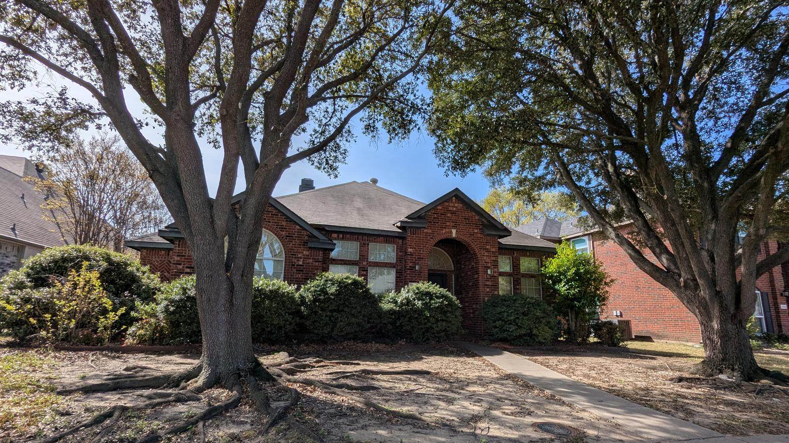 Before: tired brick, overgrown yard, and a house ready for quality work